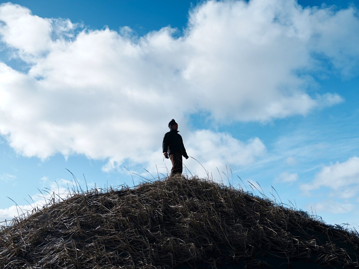 Jason Chen standing beneath a wide blue sky
