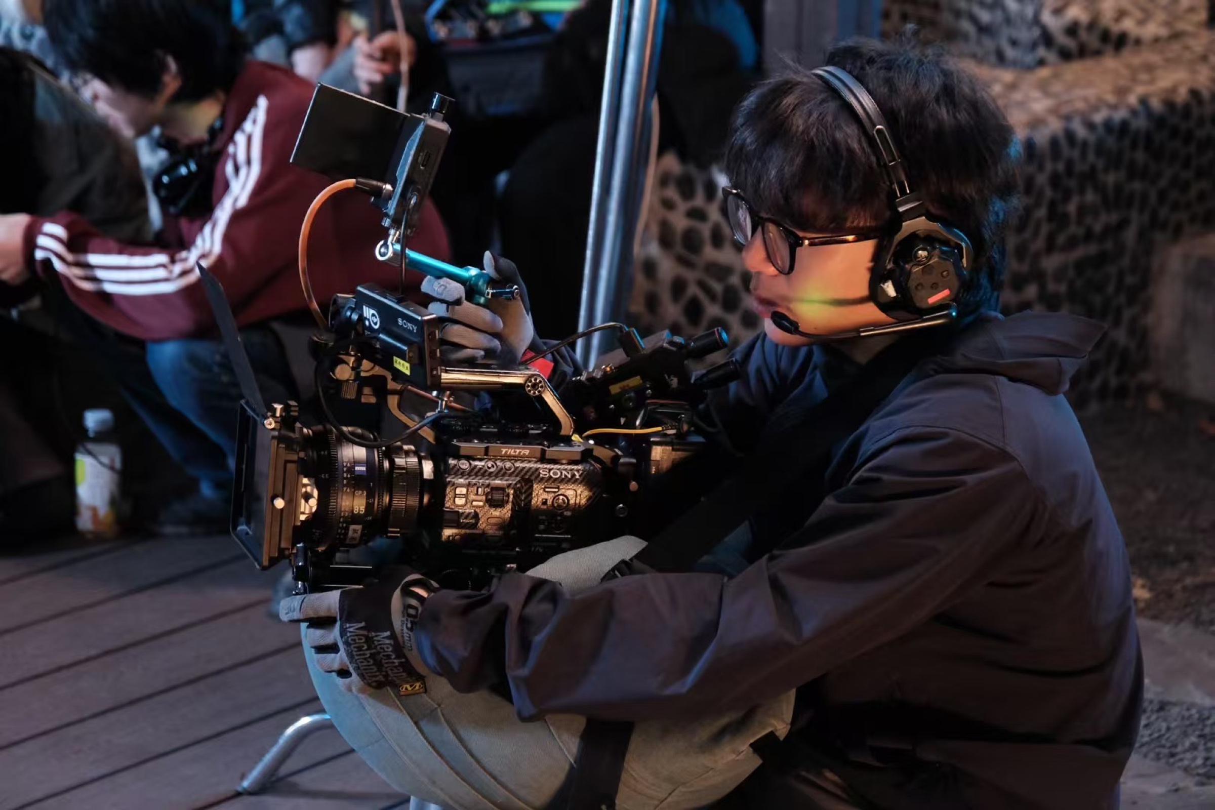 Jason Chen operating a cinema camera on set